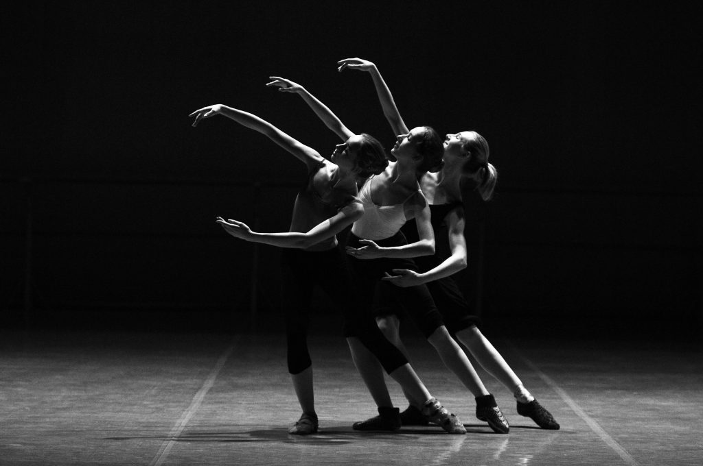 Three Dancers Performing Ballet